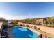 Inviting backyard pool with desert landscaping and mountain views, perfect for outdoor entertaining at 36801 N Long Rifle Rd, Carefree, AZ 85377