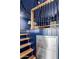 Room with blue walls, wooden stairs, and metallic storage at 36801 N Long Rifle Rd, Carefree, AZ 85377