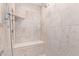 This tiled walk-in shower features a built-in bench and niche for storage of your shower accessories at 36801 N Long Rifle Rd, Carefree, AZ 85377
