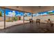 Covered backyard patio area with brick pavers, gravel landscaping and privacy wall at 3814 W El Camino Dr, Phoenix, AZ 85051