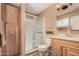 Well-lit bathroom with a glass-enclosed shower, wood cabinets, and tasteful decor at 3814 W El Camino Dr, Phoenix, AZ 85051