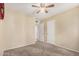 Inviting bedroom with carpet, a ceiling fan, and access to two closets at 3814 W El Camino Dr, Phoenix, AZ 85051