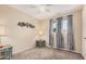 Cozy bedroom with neutral walls, carpet flooring, and windows offering ample natural light at 3814 W El Camino Dr, Phoenix, AZ 85051
