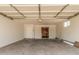 Spacious two car garage with painted walls, interior access door and a large garage door at 3814 W El Camino Dr, Phoenix, AZ 85051