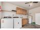 Functional laundry area equipped with a washer, dryer, sink, and storage cabinets at 3814 W El Camino Dr, Phoenix, AZ 85051