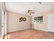 Neutral room with a ceiling fan, wood flooring, a picture window, and simple decorations at 3814 W El Camino Dr, Phoenix, AZ 85051