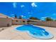 Backyard pool area with blue water, desert landscaping, and a low privacy wall at 3814 W El Camino Dr, Phoenix, AZ 85051