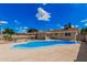Backyard view with refreshing pool, landscaped yard and single story house at 3814 W El Camino Dr, Phoenix, AZ 85051