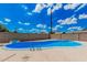 Private backyard pool with a bright blue interior and metal steps leading into the water at 3814 W El Camino Dr, Phoenix, AZ 85051