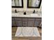 Bathroom vanity featuring dual sinks, granite counters, framed mirrors, and stylish cabinets at 4303 E Cactus Rd # 235, Phoenix, AZ 85032