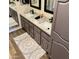 Bathroom vanity featuring dual sinks, granite counters, framed mirrors, and stylish cabinets at 4303 E Cactus Rd # 235, Phoenix, AZ 85032