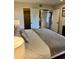 Comfortable bedroom featuring a king bed, closet, ensuite bath, and stylish decor at 4303 E Cactus Rd # 235, Phoenix, AZ 85032