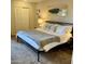 Cozy bedroom showcasing a queen bed, carpet flooring and an organized closet at 4303 E Cactus Rd # 235, Phoenix, AZ 85032