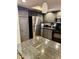 Updated kitchen with gray cabinets, granite countertops and stainless steel appliances at 4303 E Cactus Rd # 235, Phoenix, AZ 85032