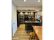 Cozy kitchen featuring gray cabinets, granite countertops, stainless steel appliances and wood-look tile floors at 4303 E Cactus Rd # 235, Phoenix, AZ 85032