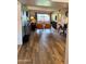 Inviting living area featuring wood-look floors and a sliding glass door with outside views at 4303 E Cactus Rd # 235, Phoenix, AZ 85032