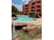 Community swimming pool features a rock waterfall design for resort style living at 4303 E Cactus Rd # 235, Phoenix, AZ 85032