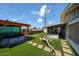 Artificial turf in backyard with a hot tub at 4323 W Rose Ln, Glendale, AZ 85301
