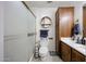 A well-organized bathroom with frosted glass shower door, and wood cabinets at 4323 W Rose Ln, Glendale, AZ 85301