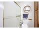 A bathroom with a frosted glass shower stall and a wooden storage cabinet at 4323 W Rose Ln, Glendale, AZ 85301