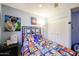 Cartoon themed bedroom featuring a ceiling fan and bright blue walls at 4323 W Rose Ln, Glendale, AZ 85301