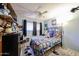 Lively bedroom featuring a ceiling fan, bright walls, and cartoon decor at 4323 W Rose Ln, Glendale, AZ 85301