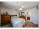 Relaxing bedroom with neutral tones, carpet flooring, ceiling fan, and attached bathroom at 4323 W Rose Ln, Glendale, AZ 85301