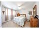 Comfortable bedroom with a ceiling fan, natural light, and stylish decor at 4323 W Rose Ln, Glendale, AZ 85301