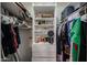 Organized walk-in closet with shelving and hanging space for clothes at 4323 W Rose Ln, Glendale, AZ 85301