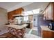 Cozy kitchen with wood cabinets, brick accents, a skylight, and modern appliances at 4323 W Rose Ln, Glendale, AZ 85301