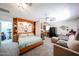 Open concept living space featuring a Murphy bed, couch, and compact kitchen at 4323 W Rose Ln, Glendale, AZ 85301