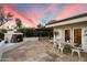 Outdoor patio featuring mosaic fireplace, dining area, tiled surface, and a covered pergola seating area at 5822 N 44Th Pl, Phoenix, AZ 85018