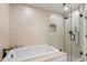 Well-lit bathroom featuring a soaking tub and a glass-enclosed shower, offering a spa-like experience in the comfort of home at 5822 N 44Th Pl, Phoenix, AZ 85018