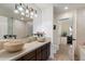 Elegant bathroom with dual vessel sinks, vanity, and a view into the adjacent office space at 5822 N 44Th Pl, Phoenix, AZ 85018