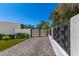 Gated driveway lined with greenery and modern fencing offering privacy and curb appeal at 5822 N 44Th Pl, Phoenix, AZ 85018