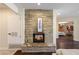 Stone fireplace in living room with decorative mantel and view of bedroom at 5822 N 44Th Pl, Phoenix, AZ 85018