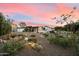 Inviting desert-landscaped front yard with modern home, updated with gravel, boulders, and specimen plants at 5822 N 44Th Pl, Phoenix, AZ 85018