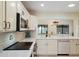 Updated kitchen featuring white cabinets, a peninsula island, and views of the dining room at 5822 N 44Th Pl, Phoenix, AZ 85018