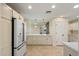Bright kitchen with white cabinetry, stainless steel refrigerator, and tiled floors at 5822 N 44Th Pl, Phoenix, AZ 85018