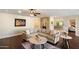 Inviting living room with wood floors, stone fireplace, and a beige L-shaped couch at 5822 N 44Th Pl, Phoenix, AZ 85018