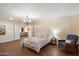 Cozy main bedroom with hardwood floors, a comfortable bed, and seating area at 5822 N 44Th Pl, Phoenix, AZ 85018