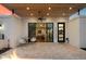 Cozy outdoor patio with a travertine tile, a pair of white chairs, ceiling fan, and access to the home's interior at 5822 N 44Th Pl, Phoenix, AZ 85018