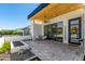 Outdoor patio with seating area, travertine tile, rock garden, and sliding glass doors at 5822 N 44Th Pl, Phoenix, AZ 85018