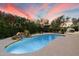 Backyard pool featuring waterfall, lush landscaping, and a covered dining area at 5822 N 44Th Pl, Phoenix, AZ 85018