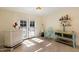 Inviting sitting area with French doors, tile floors, bar and display shelving at 5822 N 44Th Pl, Phoenix, AZ 85018