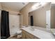 Neutral bathroom with a shower-tub, spacious vanity and an oversized mirror at 6614 S Mckemy St, Tempe, AZ 85283