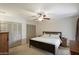 Spacious bedroom with natural light, ceiling fan, and ample closet space at 6614 S Mckemy St, Tempe, AZ 85283