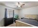 Cozy bedroom featuring a ceiling fan, natural light, and comfortable furnishings at 6614 S Mckemy St, Tempe, AZ 85283