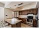 Updated kitchen featuring stainless steel appliances, laminate countertops, and updated lighting at 6614 S Mckemy St, Tempe, AZ 85283