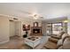Inviting living room with brick fireplace, ceiling fan, and sliding glass doors to outdoor space at 6614 S Mckemy St, Tempe, AZ 85283